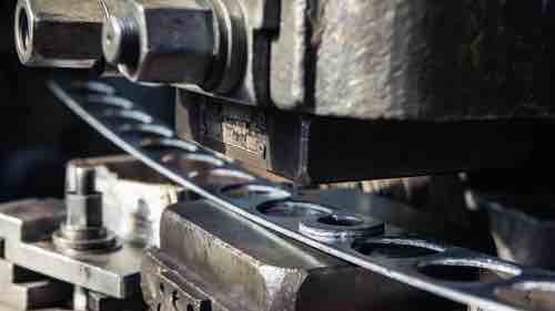 Close-up picture of a metal stamping machine for product engineering.